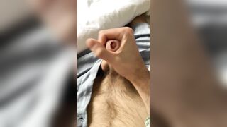 hairy guy jerks off in his bed and cums on himself