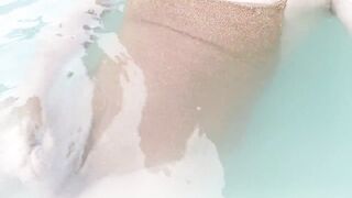 Sissy on sexy gold shiny swimsuit in jacuzzi