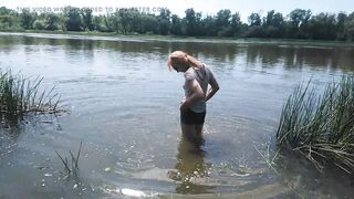 Alexa Cosmic transgirl swimming in clothes in river in jeans shirts and white t-shirt. Alexa Cosmic Wetlook Lover.
