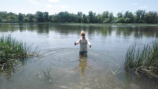 Alexa Cosmic transgirl swimming in clothes in river in jeans shirts and white t-shirt. Alexa Cosmic Wetlook Lover.